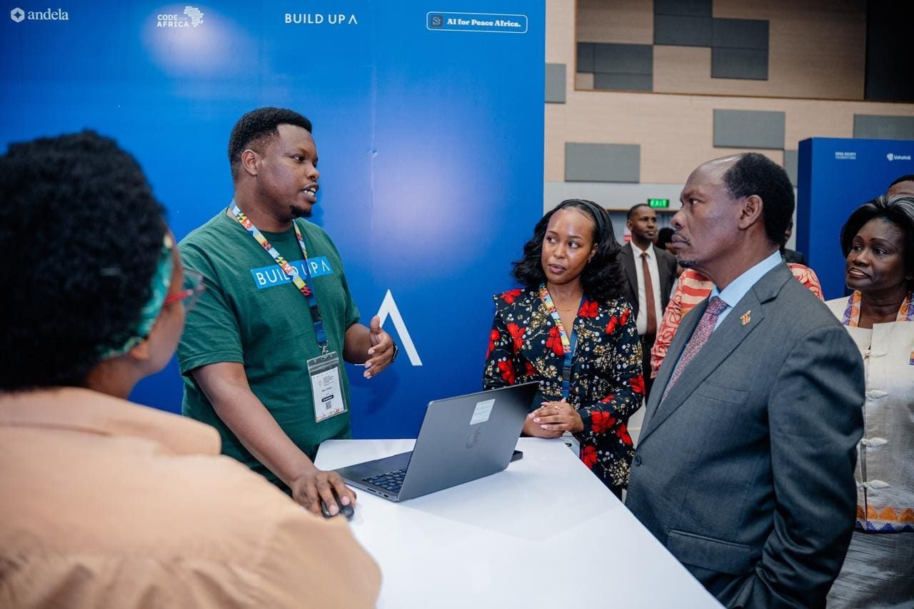 Attendees speaking with a presenter at the Build Up and AI for Peace Africa exhibition stand